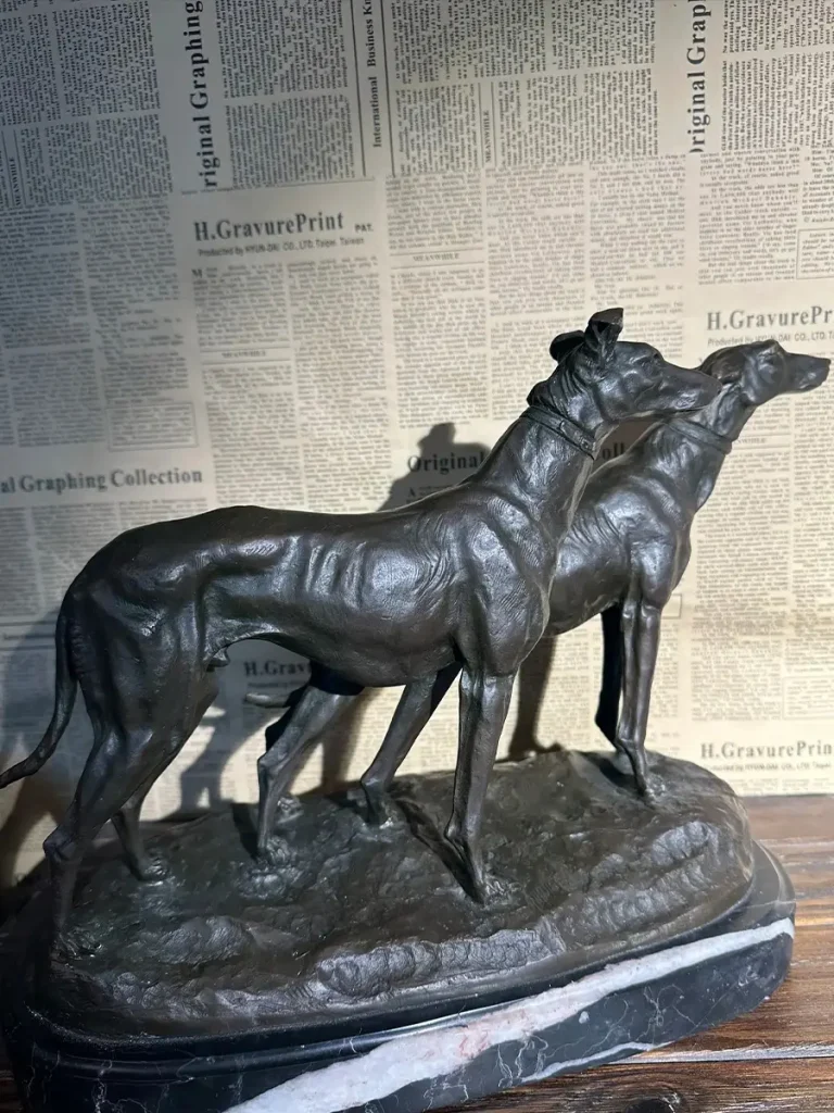 Detailed craftsmanship of an antique bronze Greyhound dog statue standing on a marble base, serving as a perfect lasting tribute.