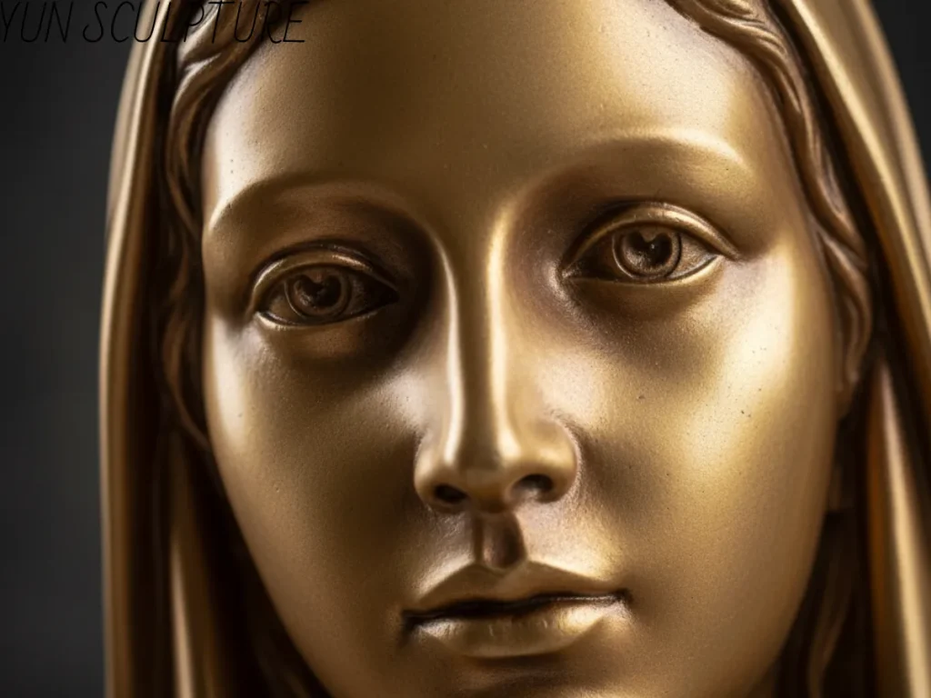 An extreme, deeply moving close-up of a monumental bronze our lady of lourdes statues outdoor, focusing on her serenely sculpted face. Utilizing our exclusive 5-Zone Patina Strategy, the metal is expertly treated with a warm, translucent gold-toned patina to evoke a living presence, completely avoiding the cheap, flaking surface paints found on resin replicas.
