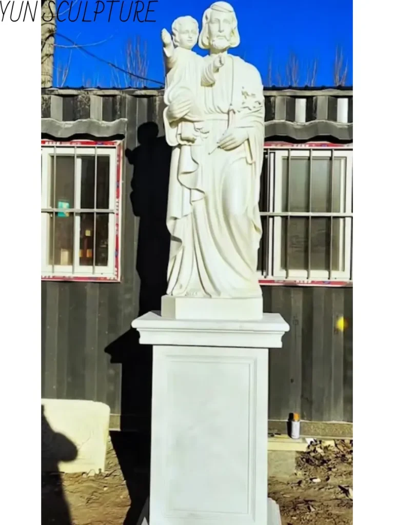 Full view of a Chinese Hanbaiyu marble statue on a high pedestal, highlighting the warmer Mediterranean-influenced aesthetic under bright sunlight.