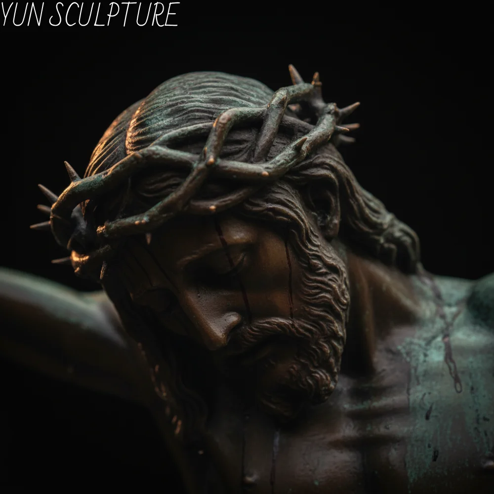An extreme, deeply emotional close-up of a bronze jesus crucifixion statue focusing on the Crown of Thorns and the bowed, sorrowful face. Masterfully cast to capture the theology of suffering, this specific "Corpus Doloroso" form is frequently specified by contemplative retreat centers and Passion devotional chapels to inspire profound reverence.