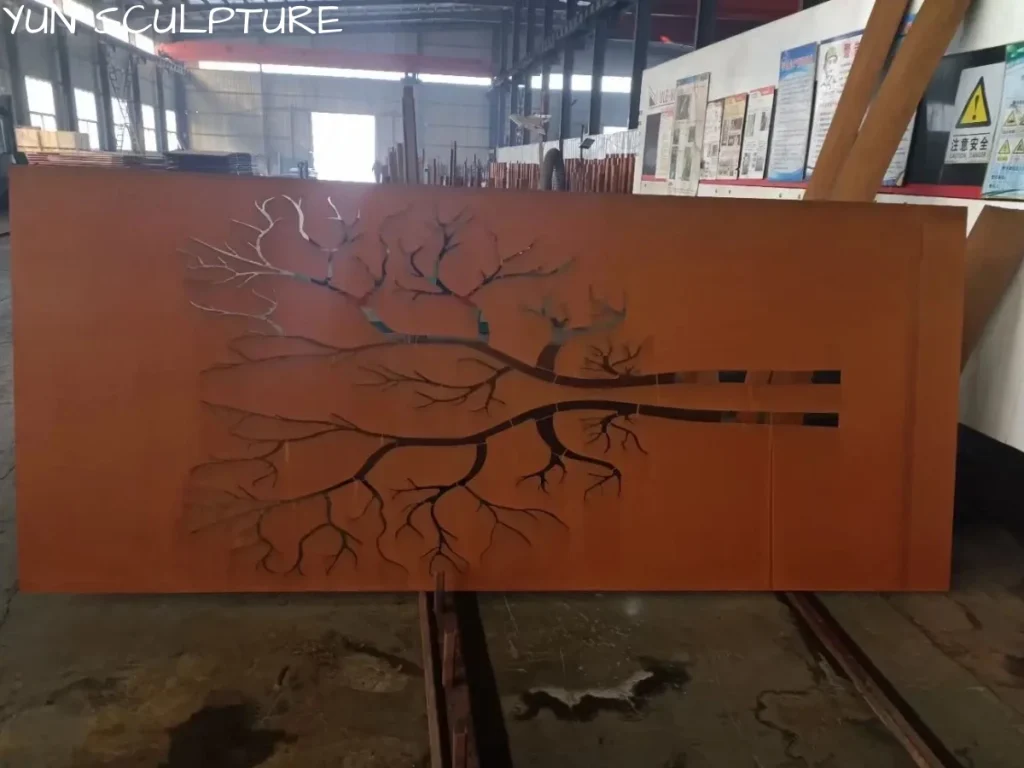 A wide Corten steel panel featuring a precision laser-cut bionic design of a delicate tree, demonstrating intricate organic patterns in metal wall art.