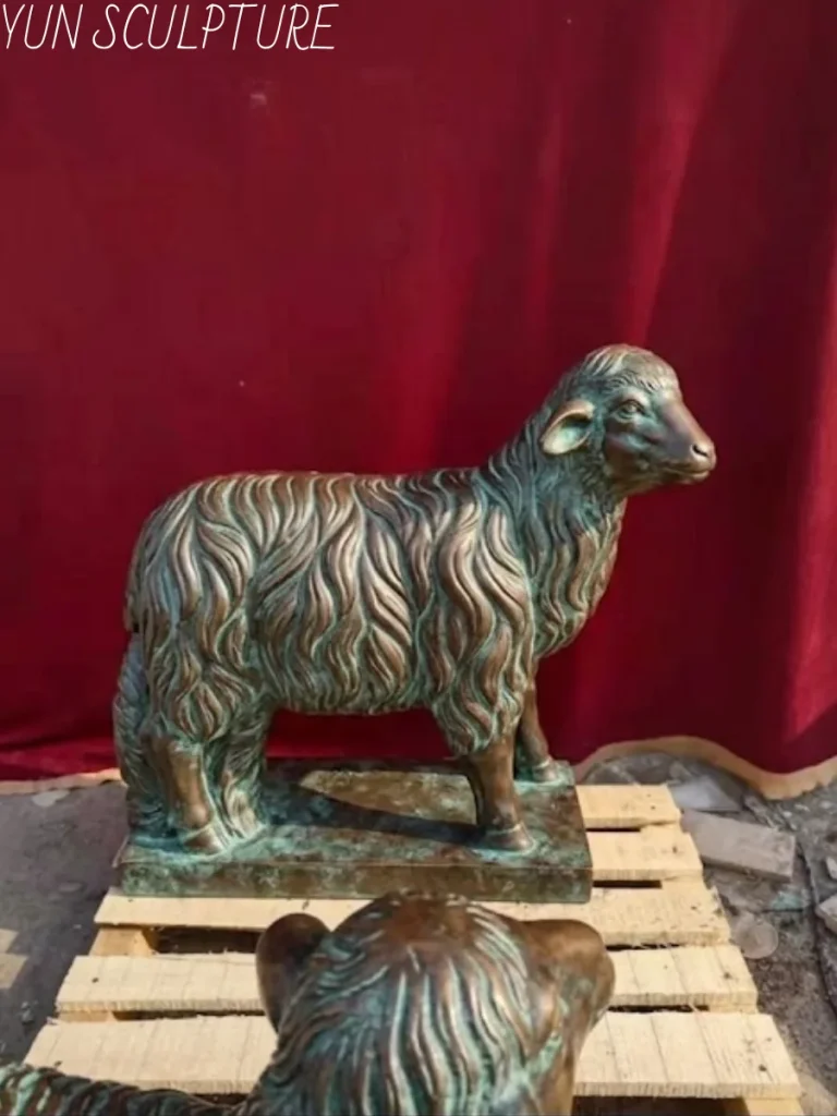 A detailed bronze lamb sculpture featuring a classic green verdigris patina and intricate wool textures, showcasing the level of personalization available for Yun Sculpture's garden commissions.