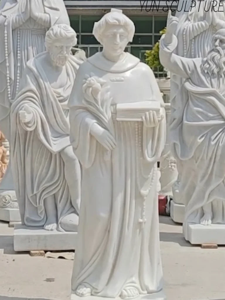 Detailed view of a custom-carved St. Anthony of Padua marble statue, showcasing the iconographic precision of the Franciscan habit and tonsure for church placement.