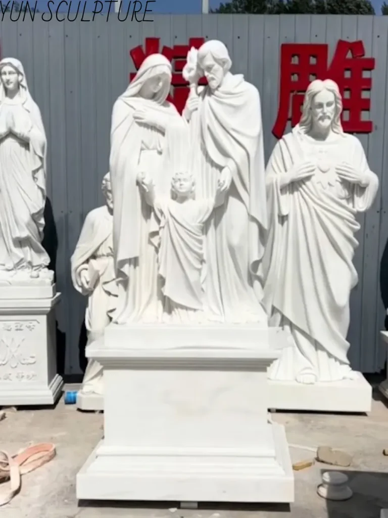 Full view of a custom-carved Catholic Holy Family sculpture in marble, illustrating the emotional circuit and welcoming presence of the Christ child.