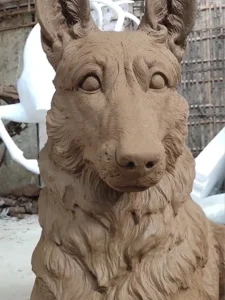 Master clay mold of a German Shepherd showcasing anatomical precision, the crucial first step in casting a life-size outdoor dog statue for high-end garden decor.