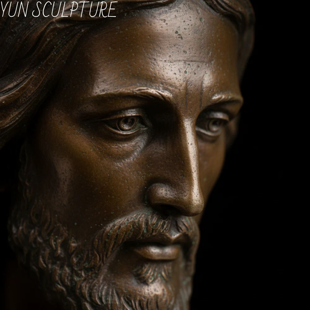 Extreme close-up of a bronze Risen Christ statue’s face, highlighting the fine craftsmanship and durable patina that withstands generations of devotion.