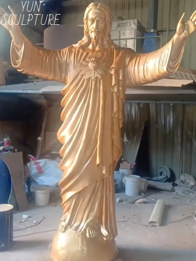 A breathtaking, newly assembled bronze resurrected Jesus statue gleaming in a sculpture workshop. The engineered skeletal framework inside the figure is designed to securely interface with a foundation anchor system, ensuring the towering masterpiece effortlessly resists lateral wind forces for generations to come.