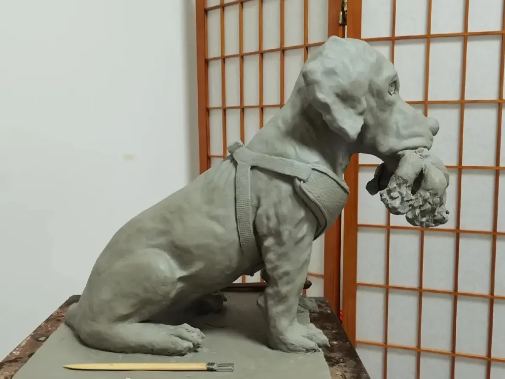 Completed clay mold of a hunting Labrador retriever ready for client approval before bronze casting.