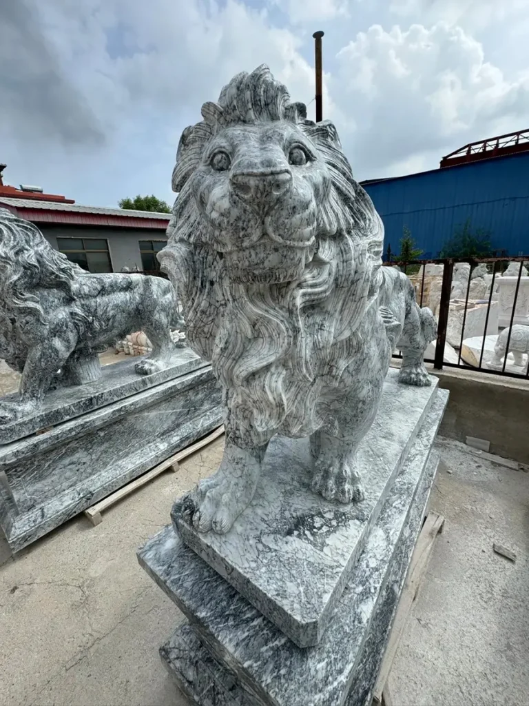 Front view of an imposing grey marble guardian lion standing proudly. The dense, non-porous nature of this exquisite natural marble prevents moisture absorption and freeze-thaw damage, preserving the incredibly fine carving of its thick mane for generations.