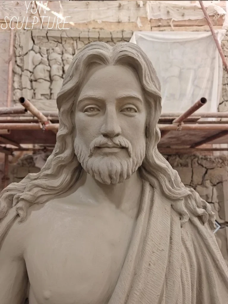 The clay model stage of a giant Jesus statue commission, illustrating the structural planning and artistic detail required for large-scale civic projects.