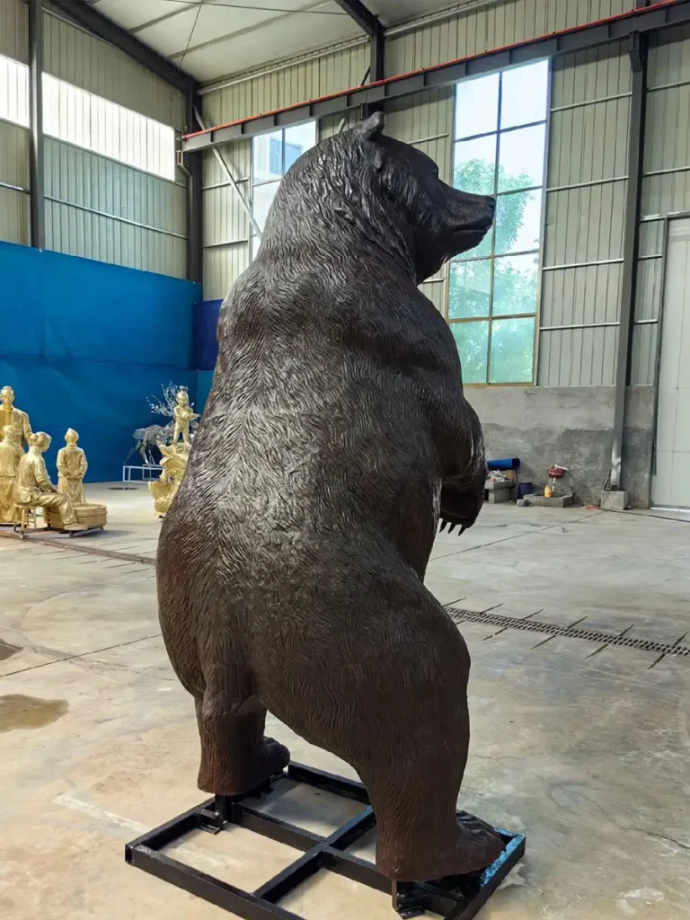 Rear-diagonal view of the finished bronze bear sculpture, showcasing the incredibly realistic grain of fur cascading down its back and legs. The meticulous lost-wax casting technique perfectly preserves these subtle textures, providing an unmatched visual depth that common alternative materials simply cannot replicate.