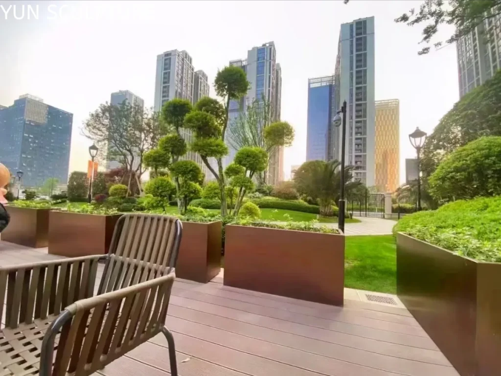 Large-scale Corten steel planters on a high-rise terrace, requiring professional engineering for load distribution and wind mitigation.