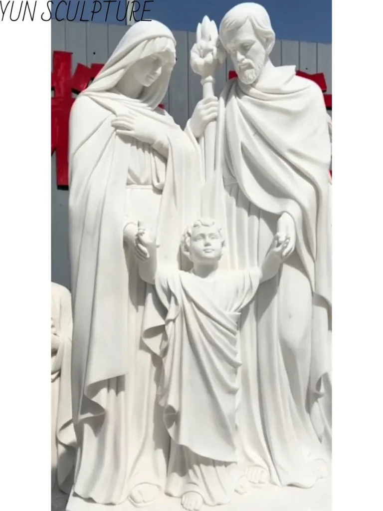 Close-up of a marble Holy Family statue showing the 'open circuit' gaze with the infant Jesus looking toward the viewer while Mary and Joseph look inward.