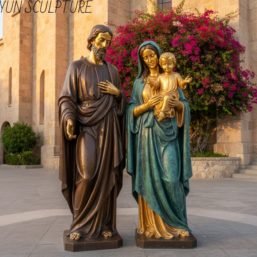 Detailed view of a bronze Jesus Mary and Joseph statue, highlighting the high-contrast gold patina on the infant Jesus as the visual focal point.