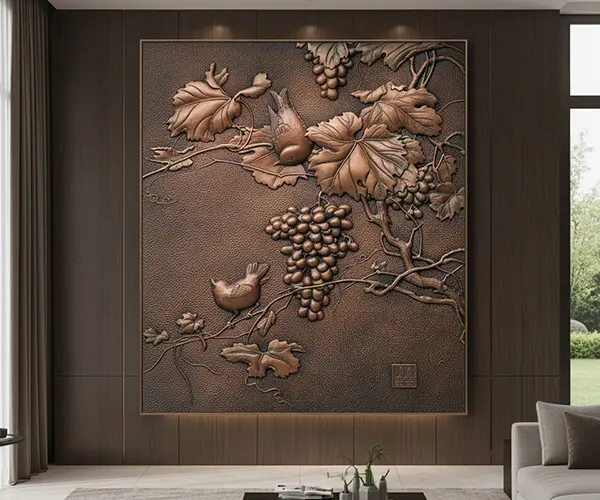 A detailed 3D metal wall art sculpture of copper grapevines and a bird. This type of large outdoor metal wall art elevates architectural spaces, offering rich textures compared to purely abstract metal wall art.