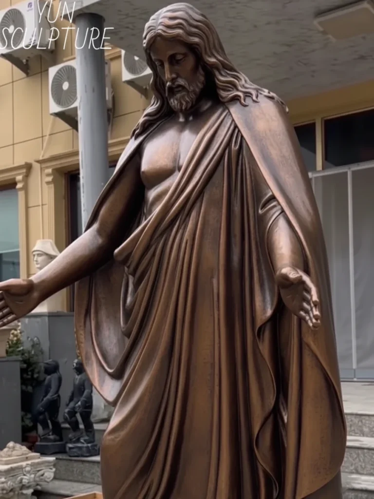 Close-up of a life-size bronze Jesus statue showing intricate facial expressions and robe folds, ideal for interior sanctuary placement.