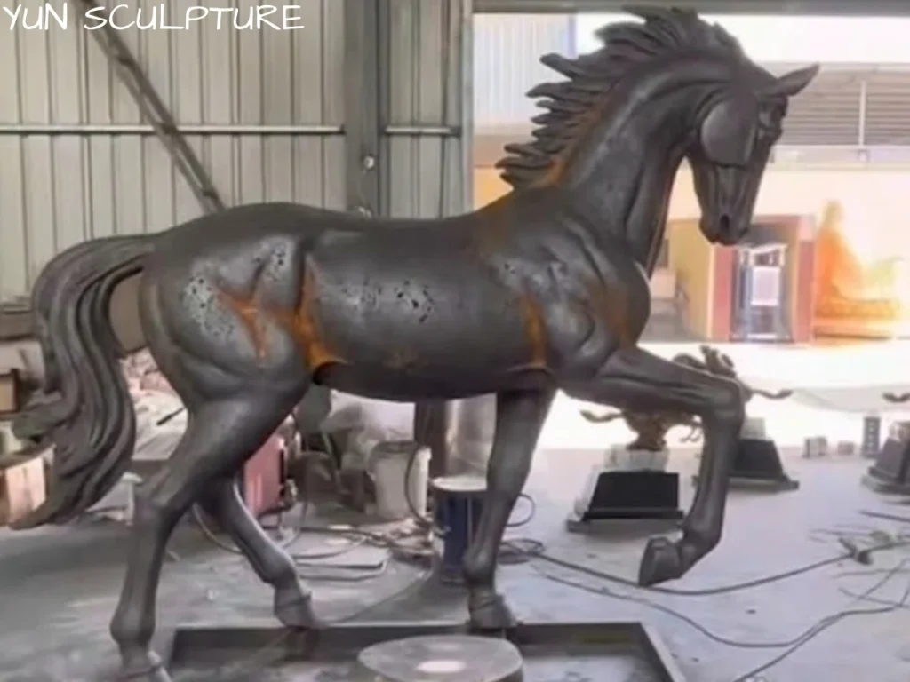 A life-size cast iron horse statue freshly manufactured in a foundry, demonstrating extraordinary anatomical precision and muscle tension captured through the fluid iron casting process.