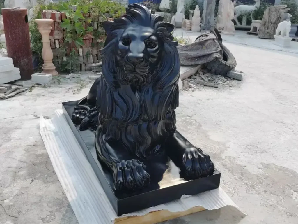 Close-up of a black granite lion sculpture featuring a majestic gaze and anatomical accuracy, perfect for luxury hardscape elements.