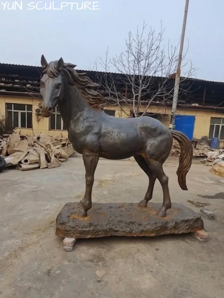 A side profile of a majestic equestrian cast iron sculpture in a factory setting, highlighting the high-fidelity casting of the mane and anatomical nuances.