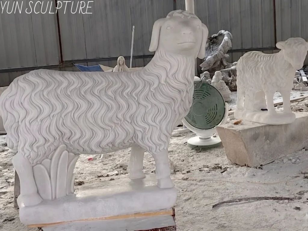 Detail shot of a white marble Good Shepherd sculpture, highlighting the textures of the stone and the lamb, produced in China's Guangxi province.