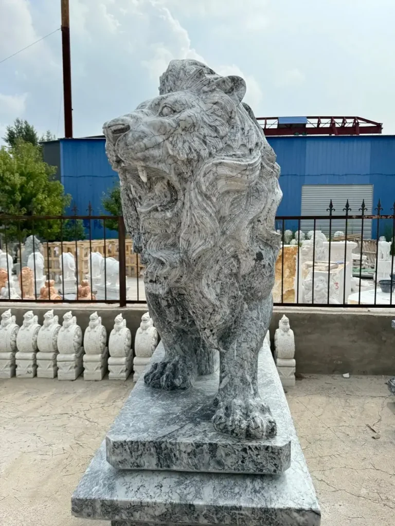 Direct front view of a standing grey marble lion statue roaring. Unlike porous mass-produced concrete that cracks during winter, this high-quality natural stone carving ensures outstanding structural stability while delivering the timeless elegance required by luxury architecture.