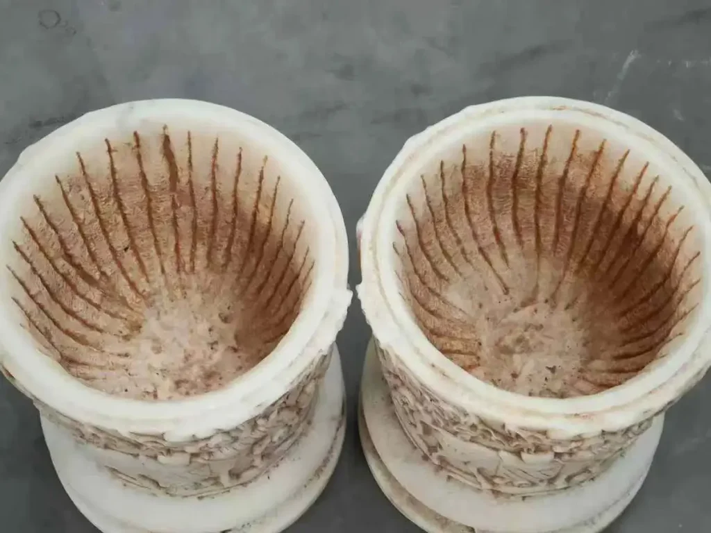 Top view of the interior of a natural stone planter, highlighting the breathable microscopic pores that should never be sealed with paint.
