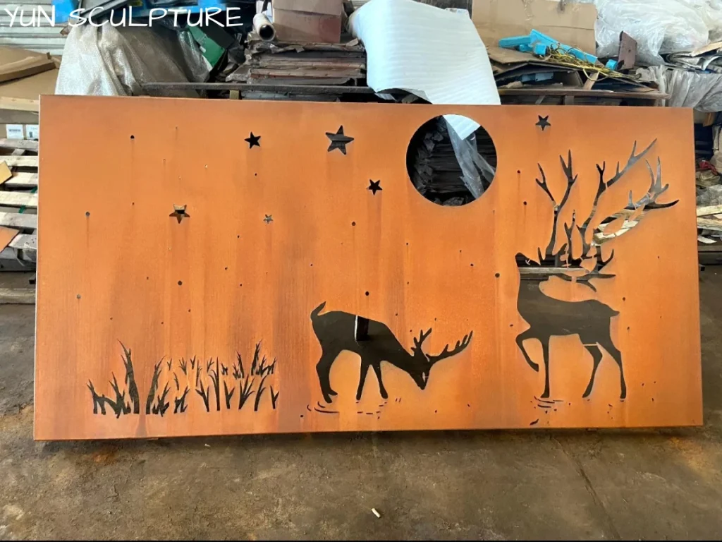 Cast iron wall sculpture panel with deer silhouette cutout in workshop