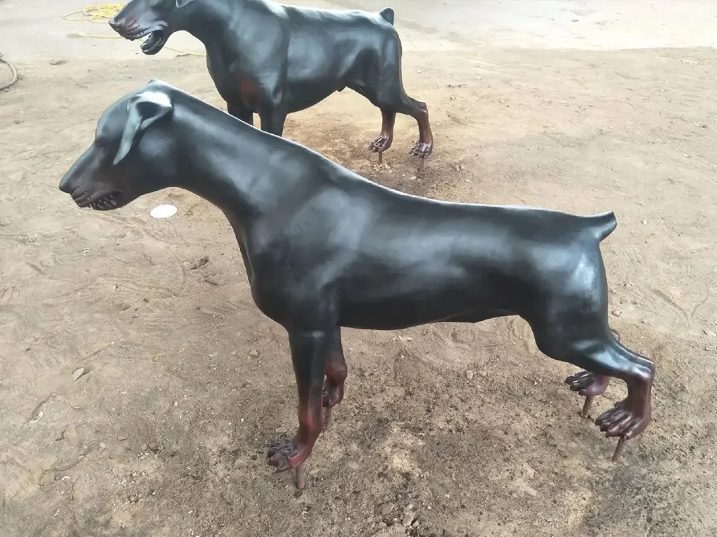 A weather-resistant outdoor black bronze Doberman statue, showcasing realistic proportions and a sturdy build as an entrance guard.