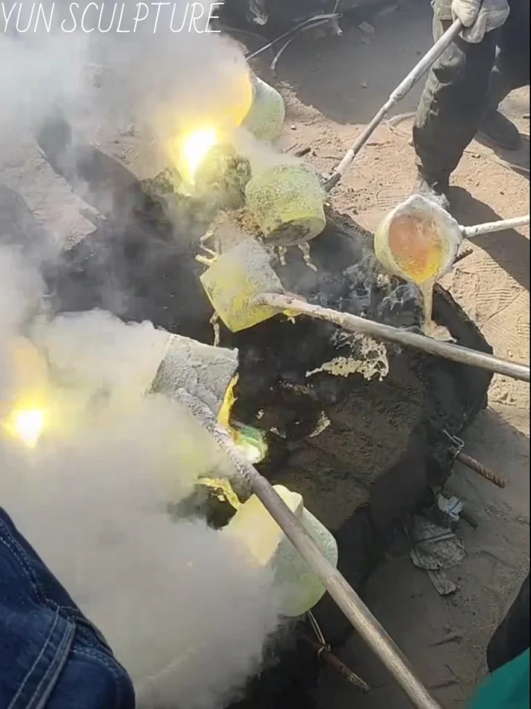 A dramatic behind-the-scenes look at the bronze pouring process in a professional sculpture foundry. The glowing molten bronze expertly fills the hollow ceramic cavities, ensuring the final metal sections will retain the precise details and extraordinary fidelity of the original clay model.