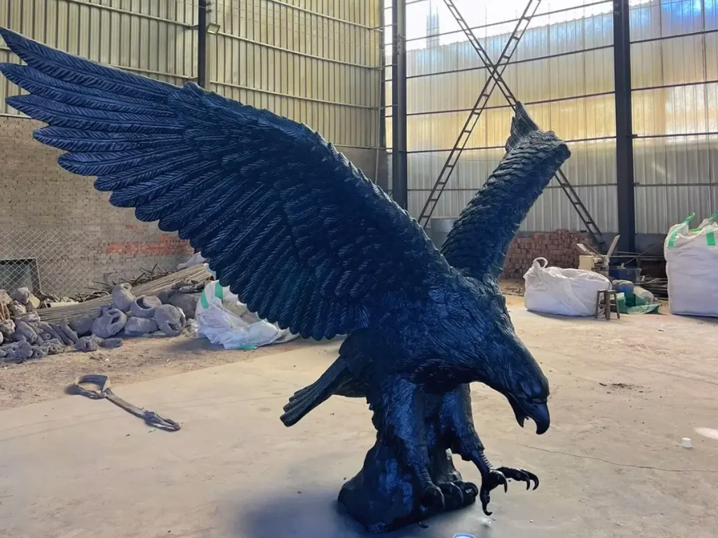A commanding bronze eagle statue captured mid-flight in a sculptor's studio. The sharp precision of its beak and talons highlights the extraordinary craftsmanship, making it an ideal symbolic guardian to create a ceremonial sense of arrival at grand driveway gates.