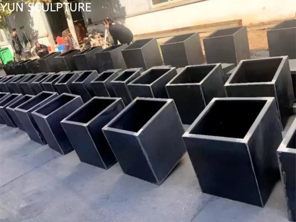 Precision-engineered metal planter boxes with clean edges and corners, illustrating the structural choreography in high-end engineering.