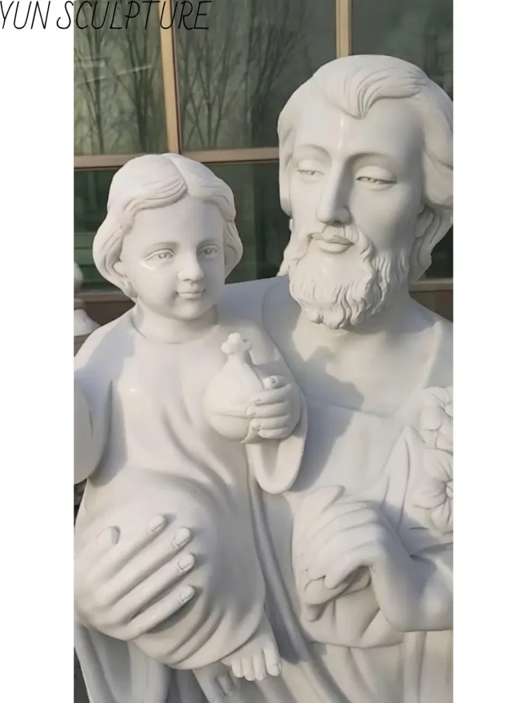 A religious marble carving of Saint Joseph and infant Jesus, showcasing the balance of mass and fine surface modeling.