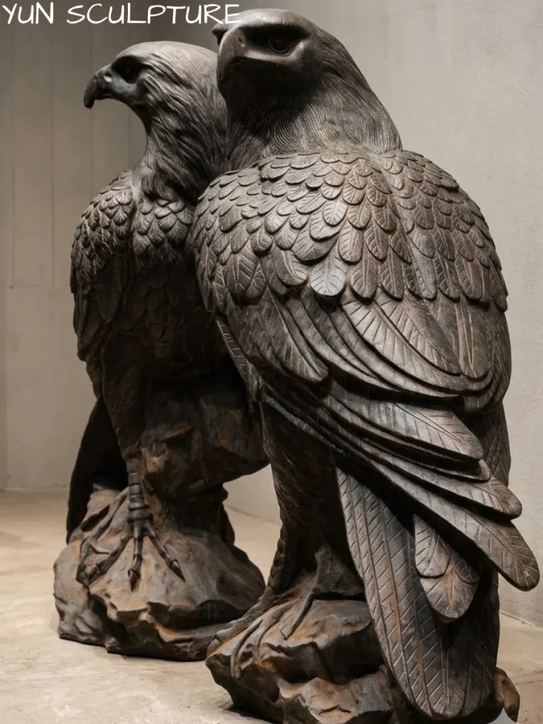 A fully restored pair of cast iron eagle statues with a robust protective coating, demonstrating how proper sealing prevents structural compromise from pitting and blistering.