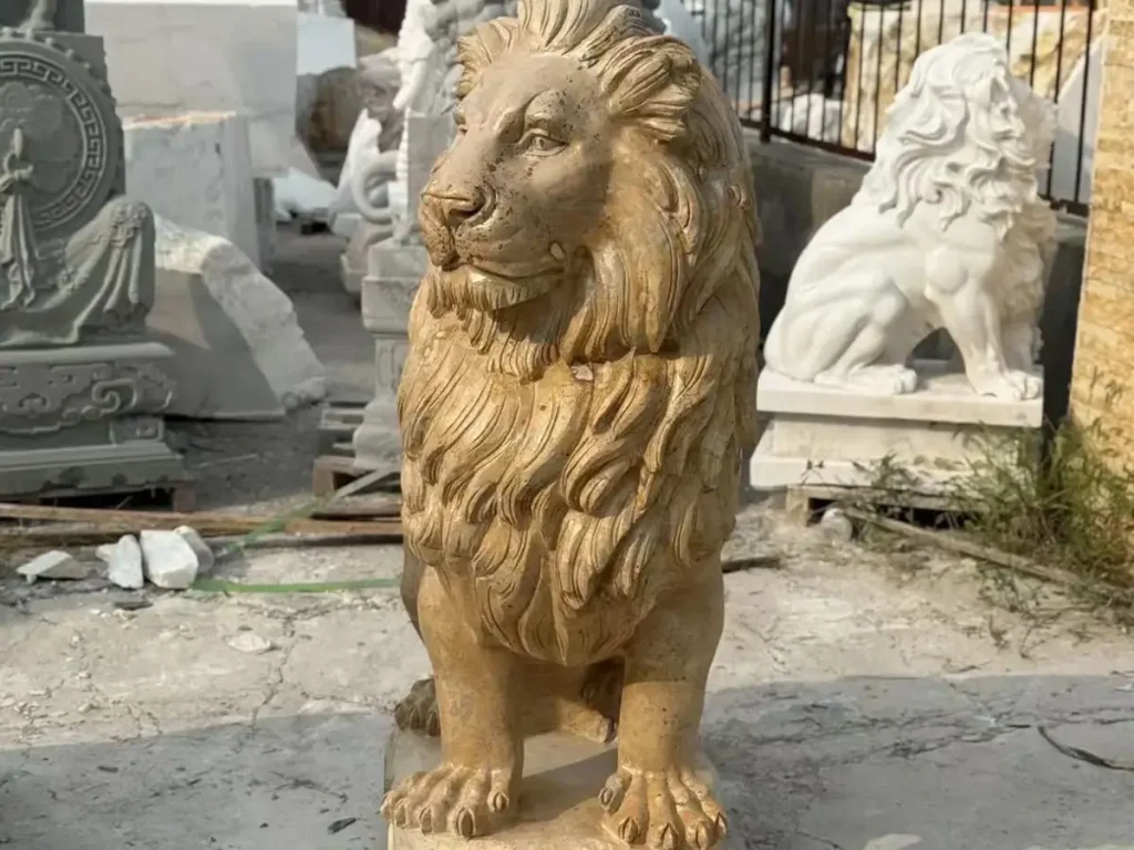 A sitting stone lion statue carved from yellow marble, demonstrating the breathing realism and structural integrity required for high-end driveway decor.