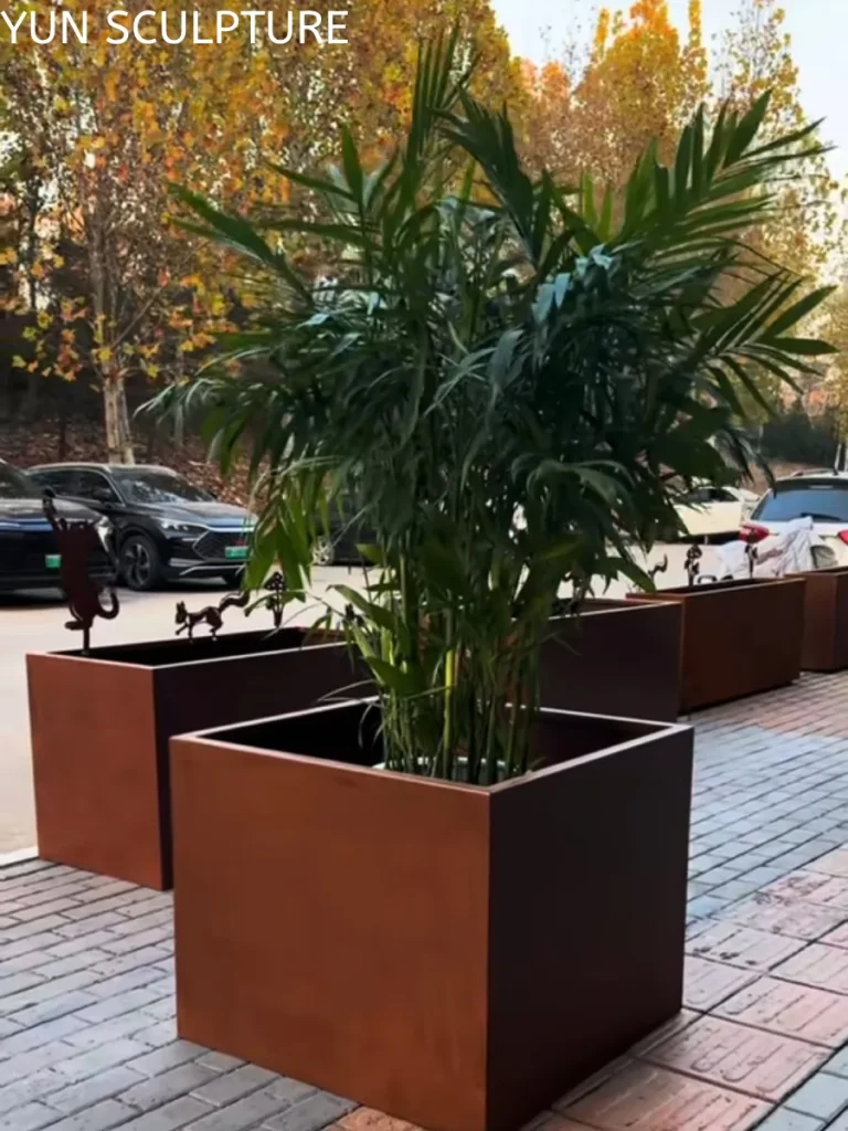 Large-scale square planters made of high-strength ASTM A588 weathering steel, designed for structural stability in high-traffic public environments.