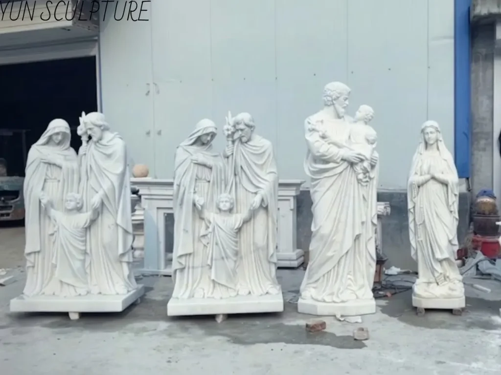 A collection of white marble Holy Family statues in different artistic poses, featuring Jesus, Mary, and Joseph as a model for Catholic Christian families.