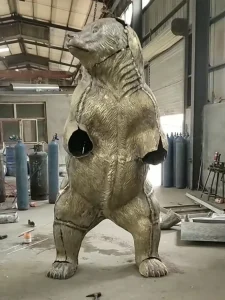 Large bronze bear sculpture in workshop