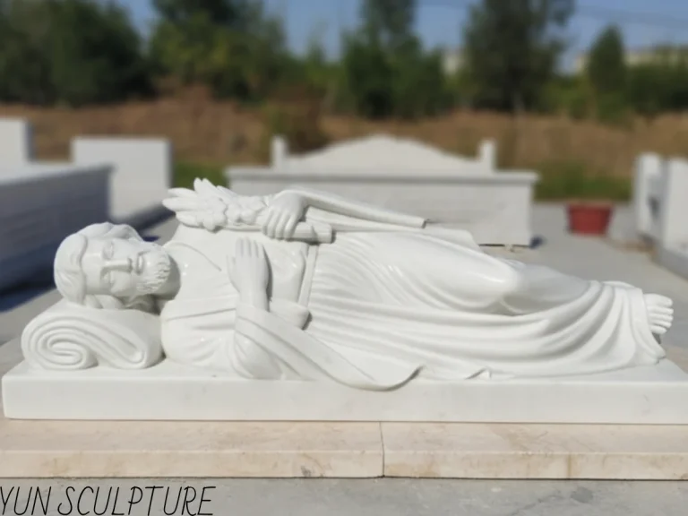 Custom white marble sleeping St. Joseph sculpture. The reclining figure demonstrates precise structural balance, resting on a thick marble base designed to safely hold believers' prayer notes.