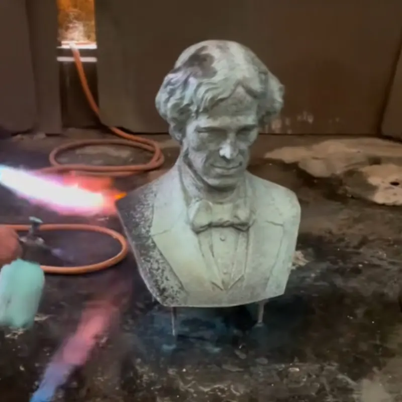 Applying chemical patina finish to bronze portrait bust sculpture