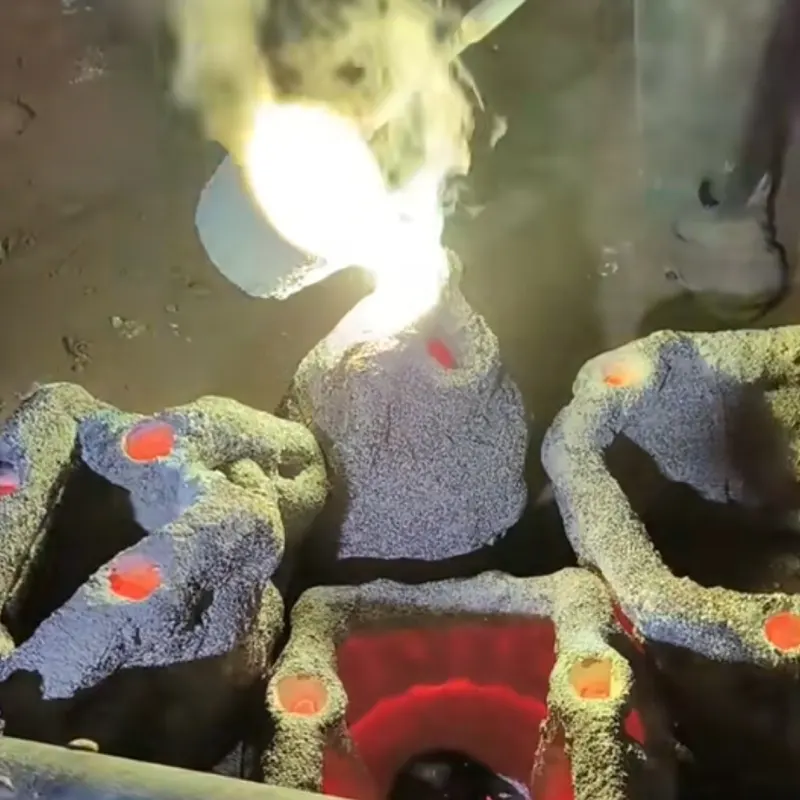 Breaking away ceramic shell to reveal raw bronze casting underneath