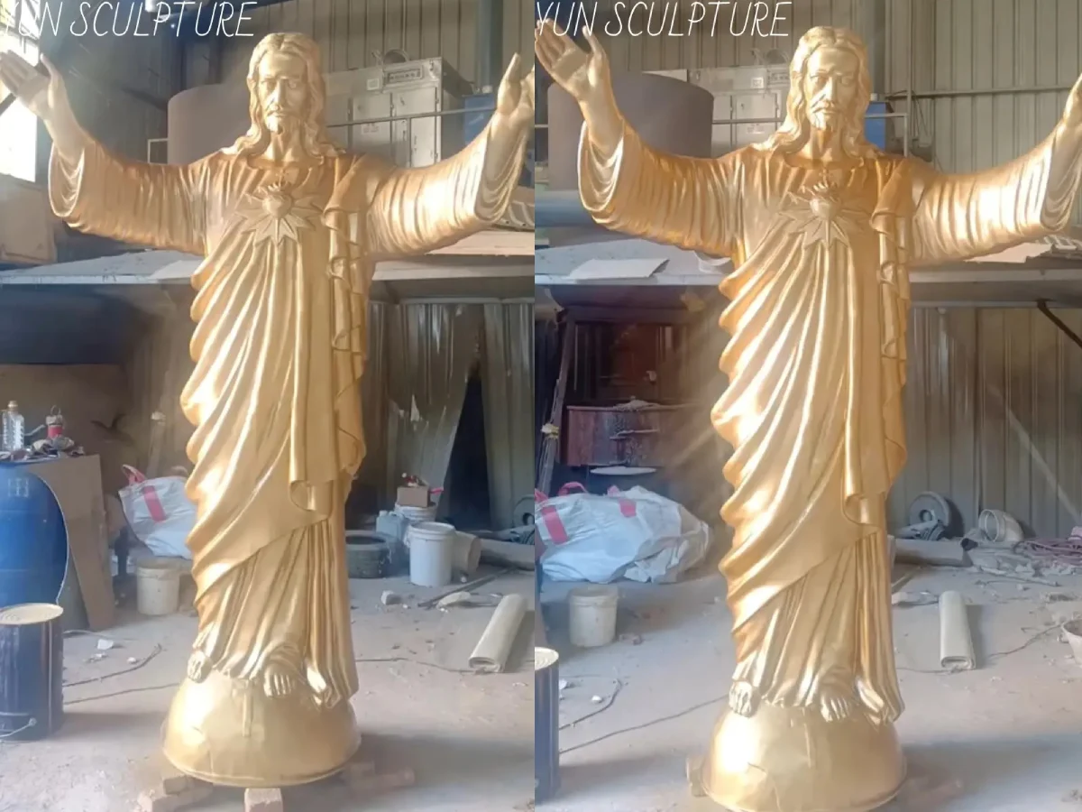 Two custom bronze Sacred Heart of Jesus statues with open arms in factory workshop