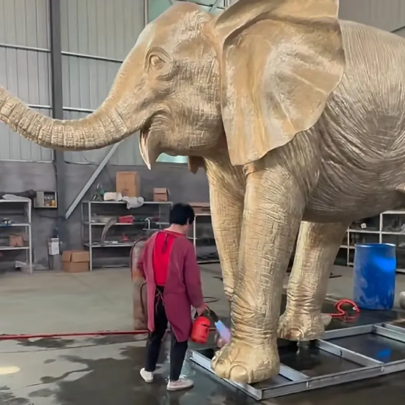 Completed life-size bronze elephant statue with natural brown patina displayed outdoors