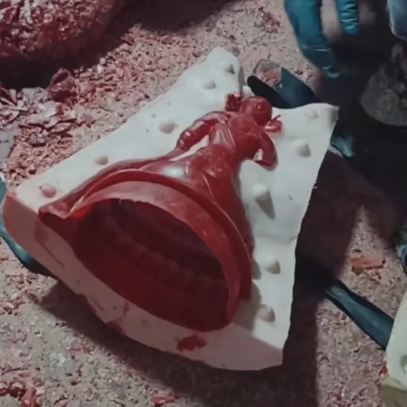 Red wax mold section cut from clay model during lost-wax casting process