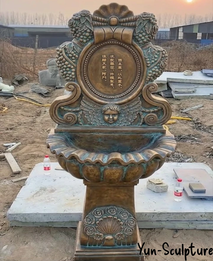 Antique bronze holy water font with carved medallion and marble column — Yun Sculpture