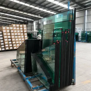 Stacks of double-layer insulated glass units (5+9A+5mm) in the factory, featuring argon-filled gaps for superior thermal insulation and energy efficiency.