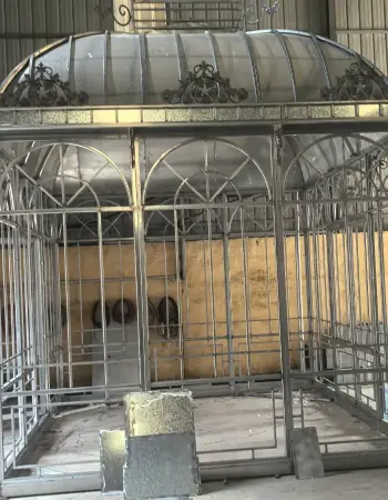 Galvanized iron lean-to greenhouse frame showing structural joints and glass panel slots