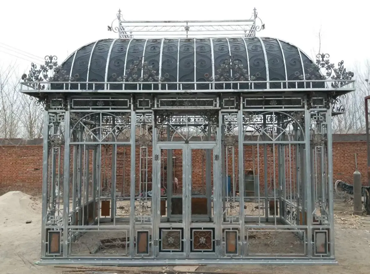 Large galvanized wrought iron Victorian greenhouse dome under construction at factory