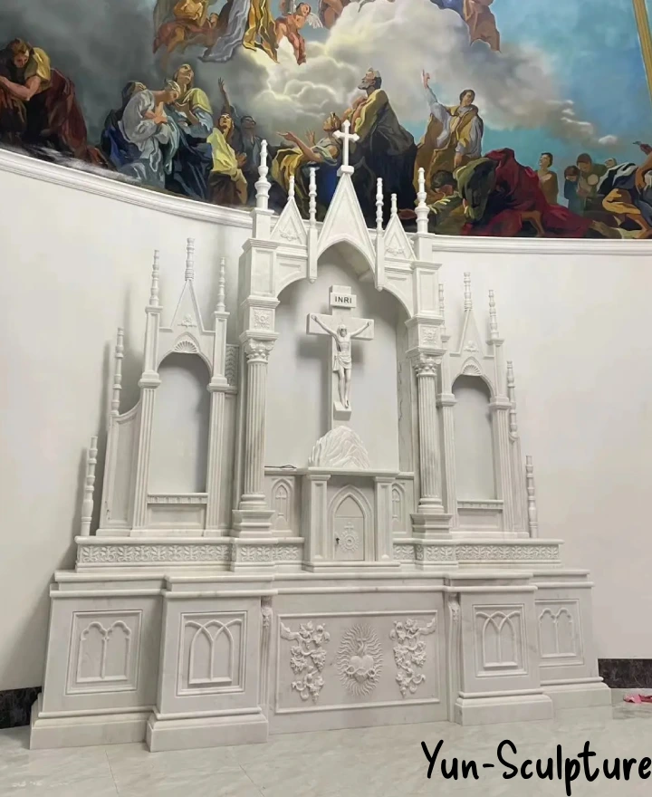 White marble Gothic altar with spires installed in Catholic church sanctuary — Yun Sculpture