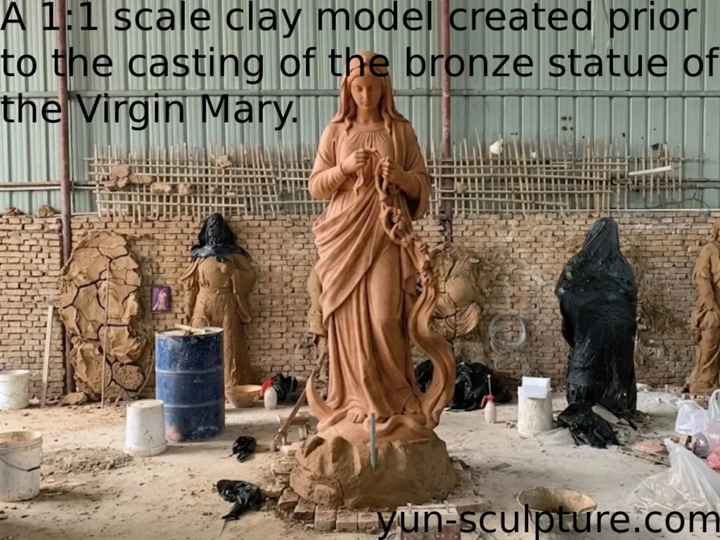 A full-scale 1:1 clay model of a Mary Undoer of Knots statue standing in a sculptor's dusty workshop. This critical maquette stage allows clients to approve the complex three-dimensional flow of the ribbon—from tension to release—before any permanent white marble or bronze material is committed.