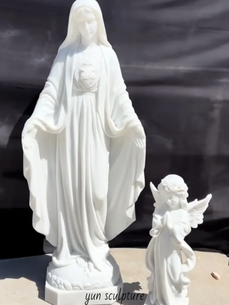 Custom carved marble sculpture of the Virgin Mary standing beside a small praying angel, made from solid natural materials to ensure durability and prevent internal moisture migration.